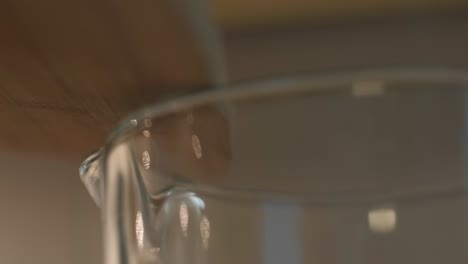 Woman-puts-a-pieces-of-banana-in-the-bowl-of-a-blender,-close-up-shot