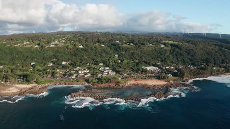 Aerial-push-in-and-tilting-down-shot-on-Shark-Cove-on-the-North-Shore-of-O'ahu,-Hawaii