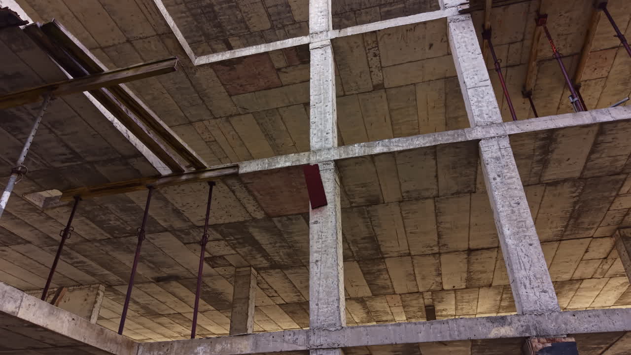 Exploring the intriguing lines and structures of an abandoned construction site at dawn, revealing nature's reclamation through light and shadow