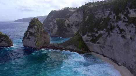 Formaciones-Rocosas-De-Piedra-Caliza-En-Diamond-Beach-En-Nusa-Penida,-Indonesia---Disparo-Aéreo-De-Drones