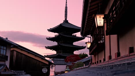 the yasaka pagoda in kyoto stands beautifully illuminated by the warm hues of the setting sun, casting its tranquil silhouette against the sky.
