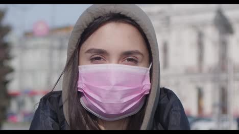 woman wearing a pink face mask
