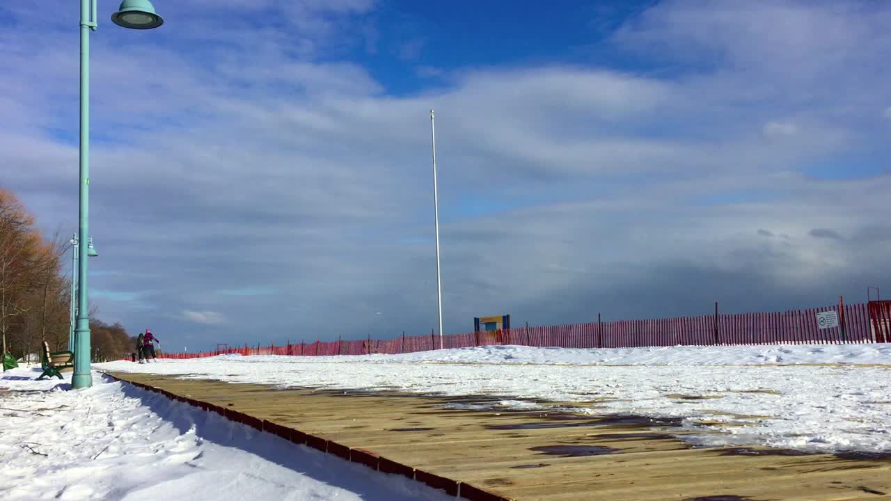 Winter boardwalk scene with people