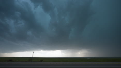 vehicles driving under dark storm clouds fast movement and threatening skies