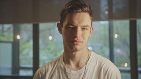 Casual-Male-Model-In-White-Undershirt-Smiling-At-The-Camera