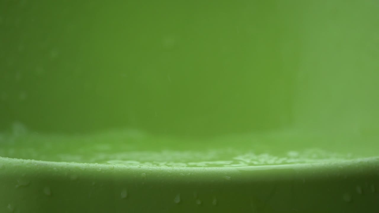 капли воды и брызги с зеленым пластиком на дне