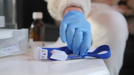 close-up of medical staff picking up a snap tourniquet band