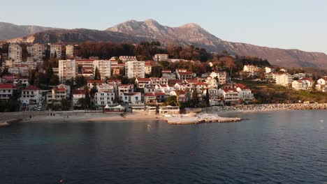 aerial view of small coastal town built in beautiful mountains at the seaside