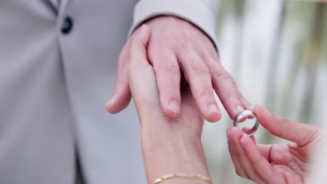 couple, holding hands and ring for marriage