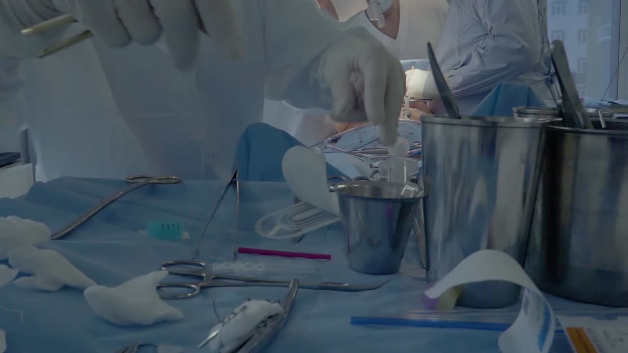 Medical staff during a heart operation 4 A nurse is preparing tools
