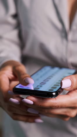close-up of hands typing on a smartphone screen