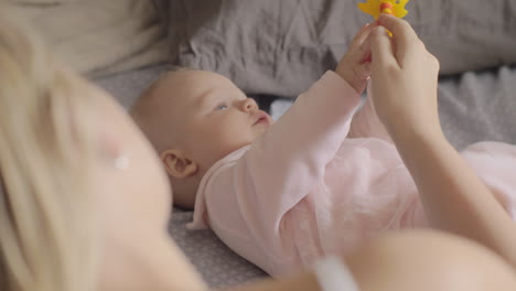 Mother-playing-with-her-newborn-daughter