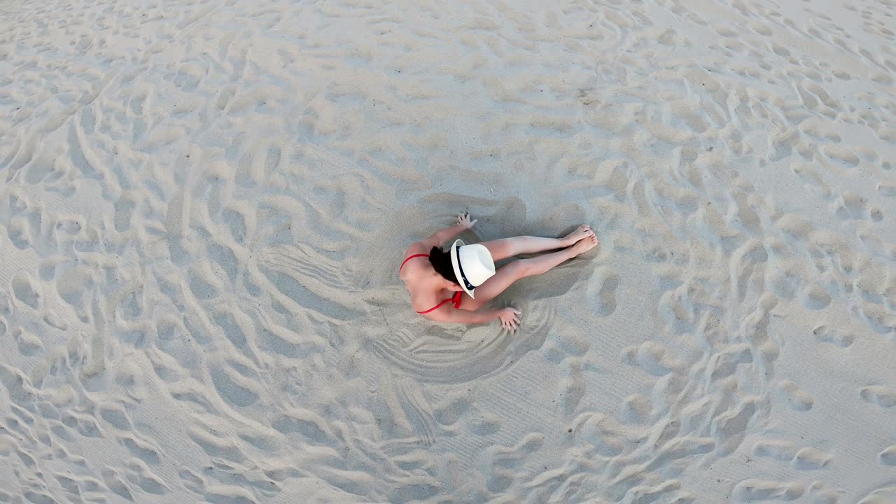 Top Aerial Drone View Of Woman In Swimsuit Bikini Relaxing And Sunbathing Beach Near The Ocean