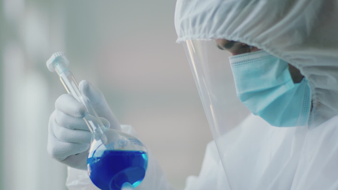 Scientist in protective gear working in a lab