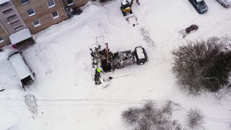 team building electricity poles with heavy equipment, winter season