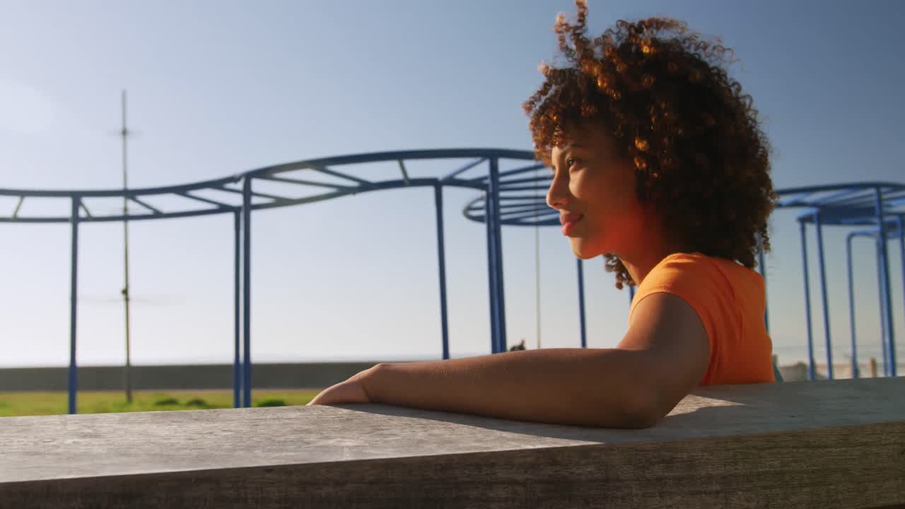 Woman looking away and smiling in a park