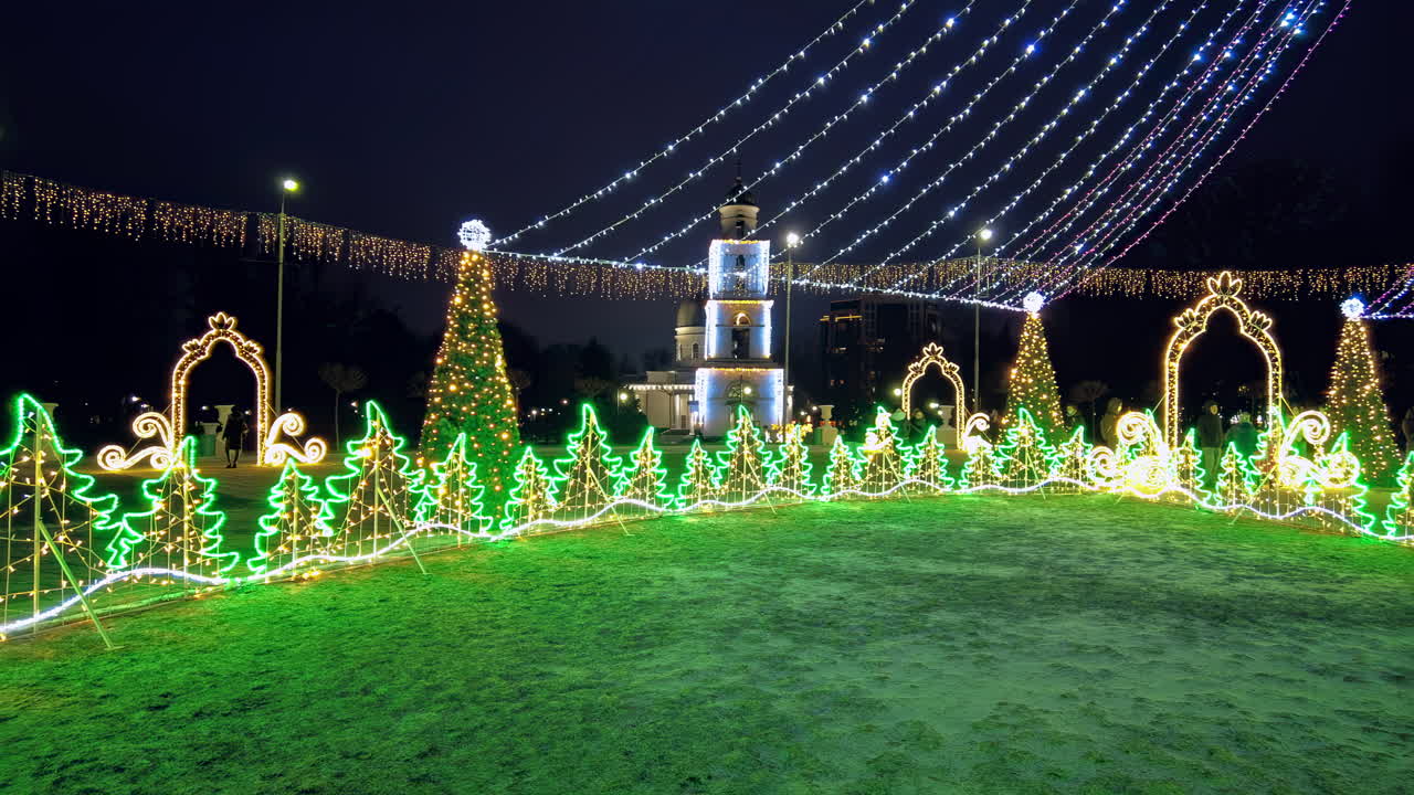 Chisinau, Moldova - December 20, 2021: Beautifully decorated park comes alive with twinkling holiday lights and vibrant Christmas trees during the festive evening celebration, creating a magical atmosphere