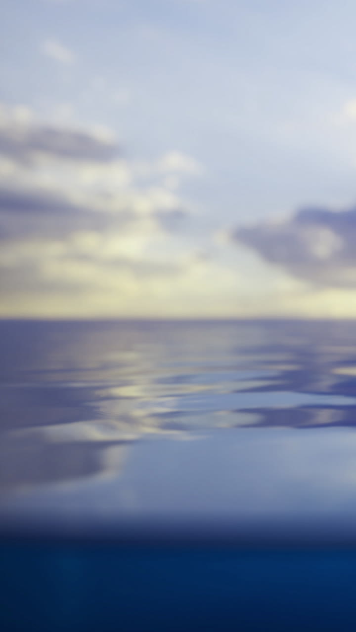 Water surface reflects clouds with gentle ripples at sunset