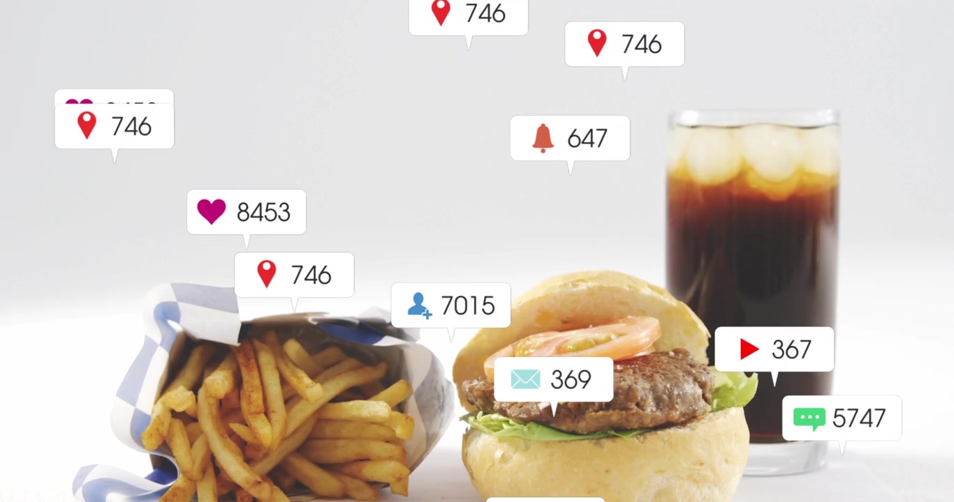 Vertical video: Notification bubbles appearing above burger fries soda on gray table, showing buzz