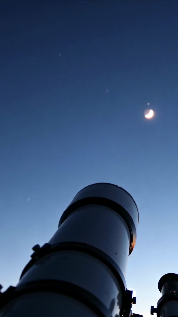 Vertical video: Camera tilting, telescope holding steady, aiming crescent moon, stars for astronomy
