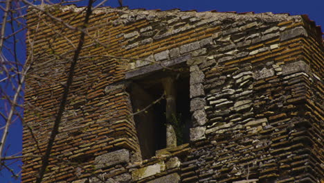 ancient window of a building made of bricks at the old town of pedraza, spain