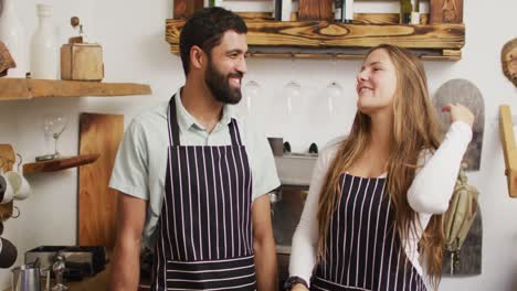 video of happy diverse female and male sellers in coffee shop