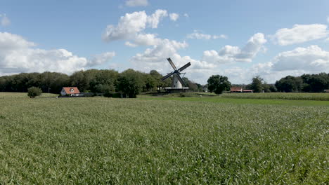 wide shot of windmill on beautiful farmlands