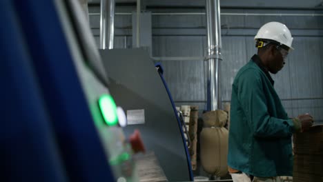 factory worker handling wooden boards