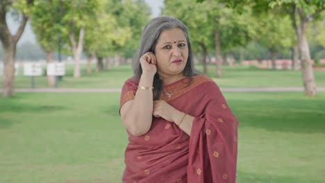 Guilty-Indian-old-woman-apologizing-and-saying-sorry-in-park