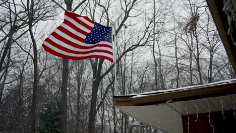 a late winter flurry blowing through an american flag