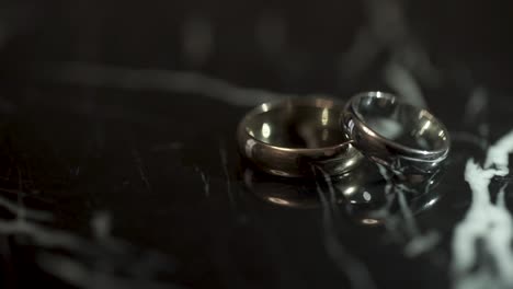 two wedding rings on marble surface