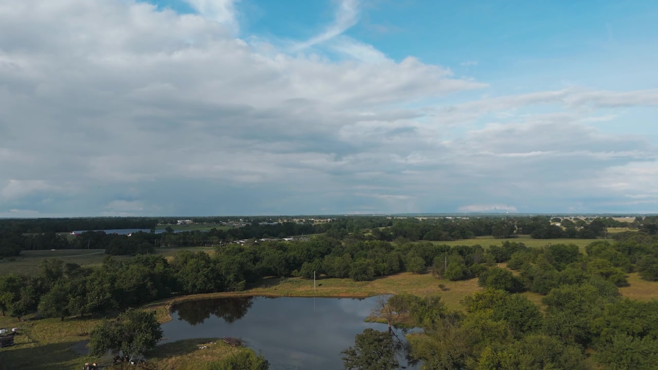 Quiet Pond Surrounded By Dense Forests Near Gentry, Arkansas, United States. Aerial Tilt-down Shot