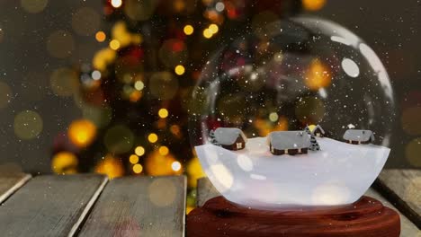 Christmas-animation-of-snow-houses-in-snow-globe-on-wooden-table-4k-
