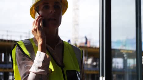 Female-engineer-talking-on-mobile-phone-4k