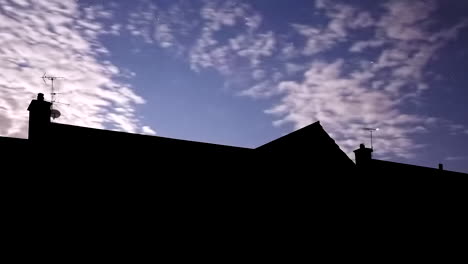 Narrow-Time-Lapse-of-Rural-Country-Home-at-Night-with-Purple-Clouds-Clearing-to-Reveal-a-Starry-Nights-Sky