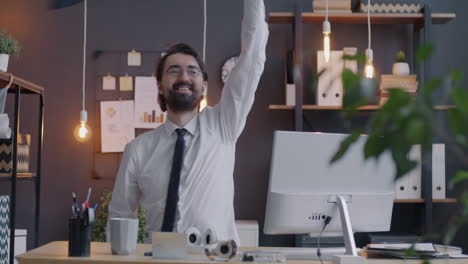 happy businessman celebrating in office