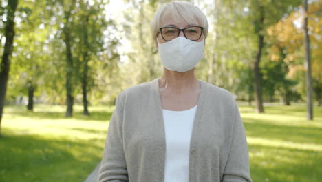 senior woman wearing a mask in a park