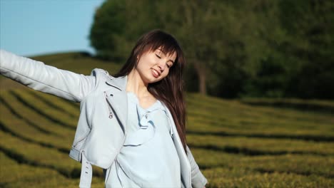 woman enjoying a sunny day in a tea plantation