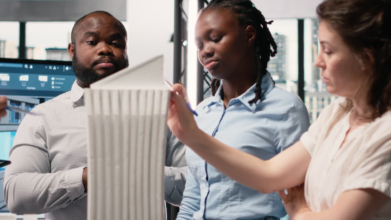 Vertical Video Diverse real estate developers analyze zoning regulations for construction