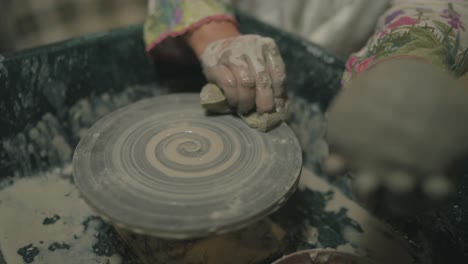 cleaning of pottery wheel by rotating it prior to next pottery.