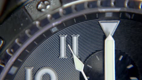 detail shot of the second hand of a wristwatch approaching twelve o'clock