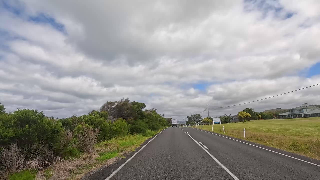 A 14-second drive along Great Ocean Road, showcasing lush greenery, open skies, and a peaceful rural setting