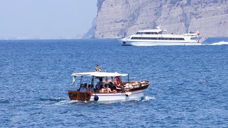 small boat navigating near larger vessel in sorrento