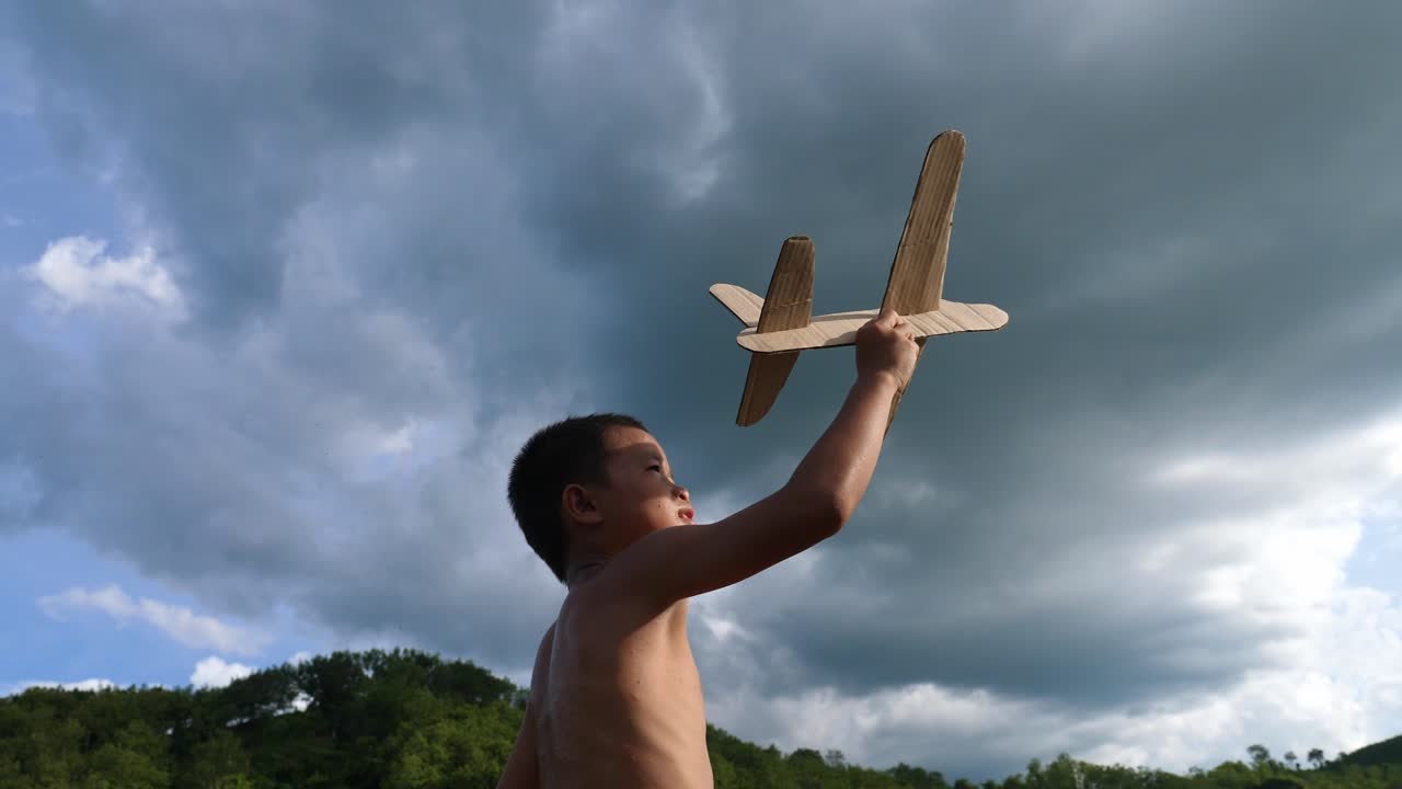 Boy playing with a toy airplane