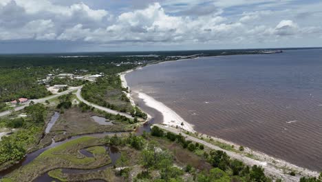 coastal aerial showing suburban wetland beachfront with curved shoreline, 30a, florida, usa