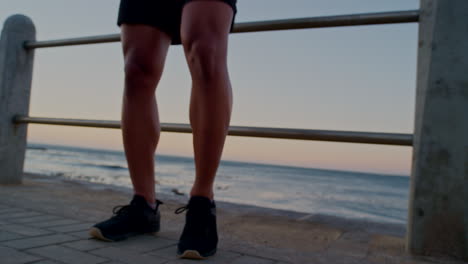 stretching, running and face of man at beach