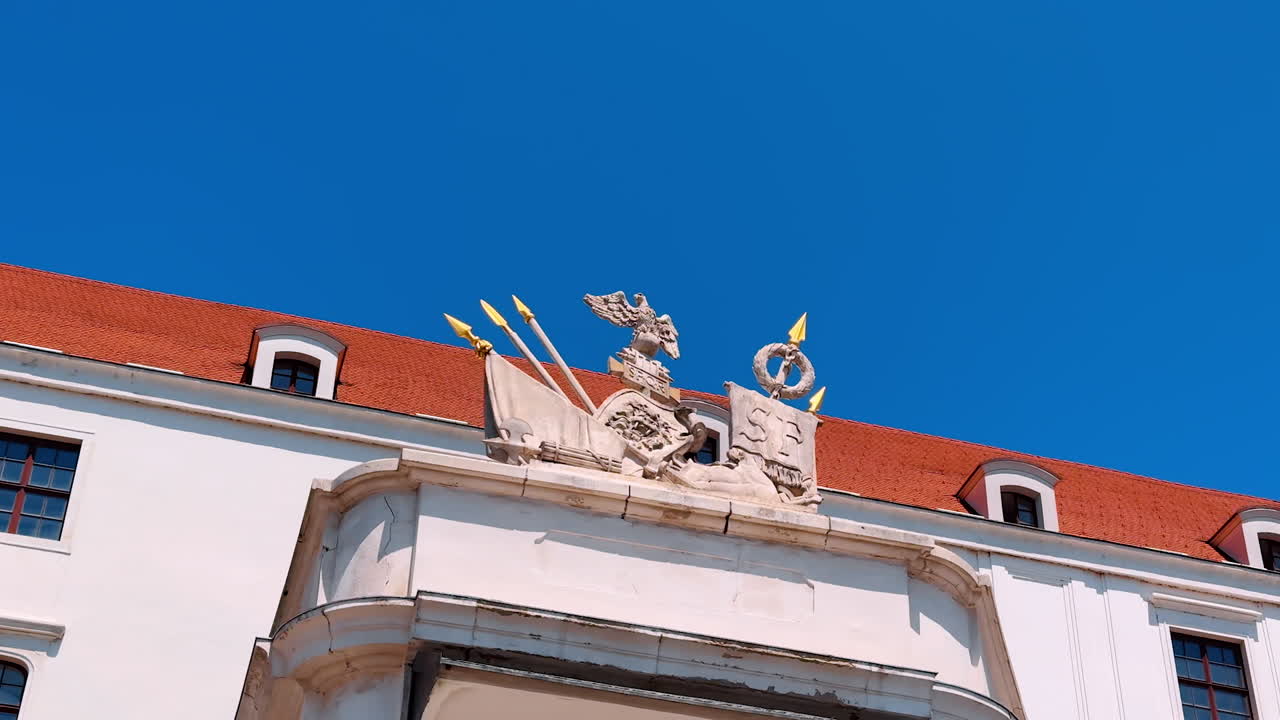 Decorative elements ornamenting the historical architecture. Low angle view at the heraldic symbols at Bratislava Castle in Slovakia