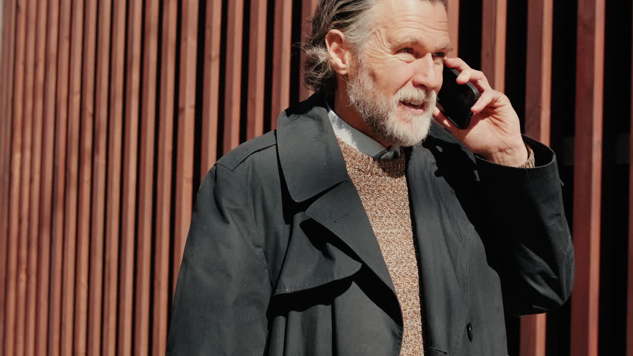 Stylish Older Businessman Talking on Phone in City