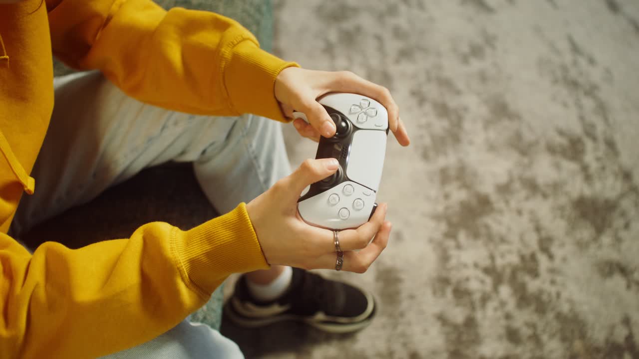 Person playing video game with a controller