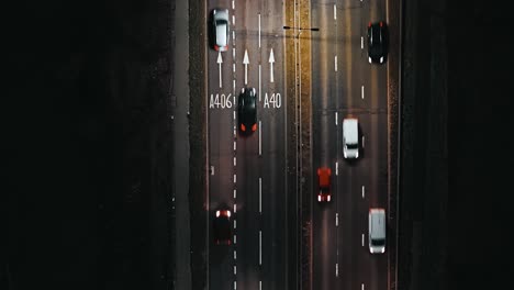 evening commuter traffic on london a40 road, aerial top-down shot at night